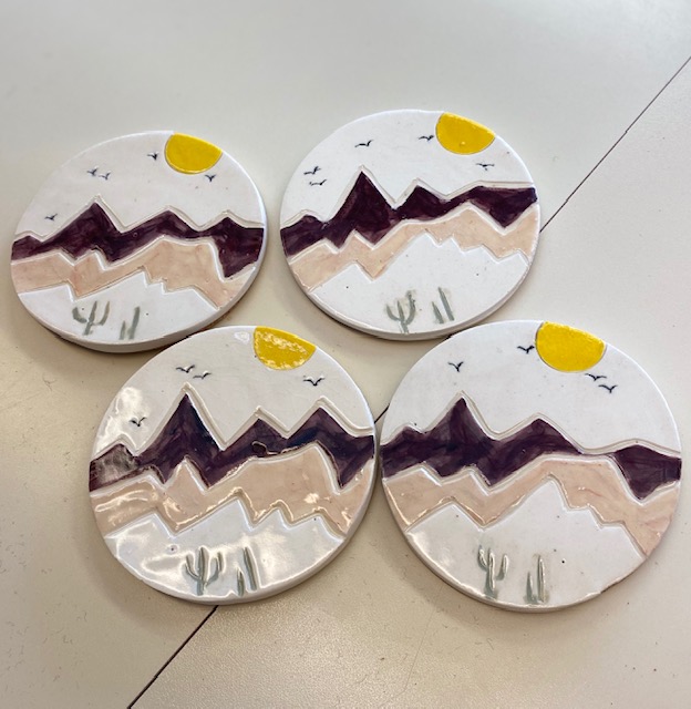 Set of round ceramic coasters with mountain designs