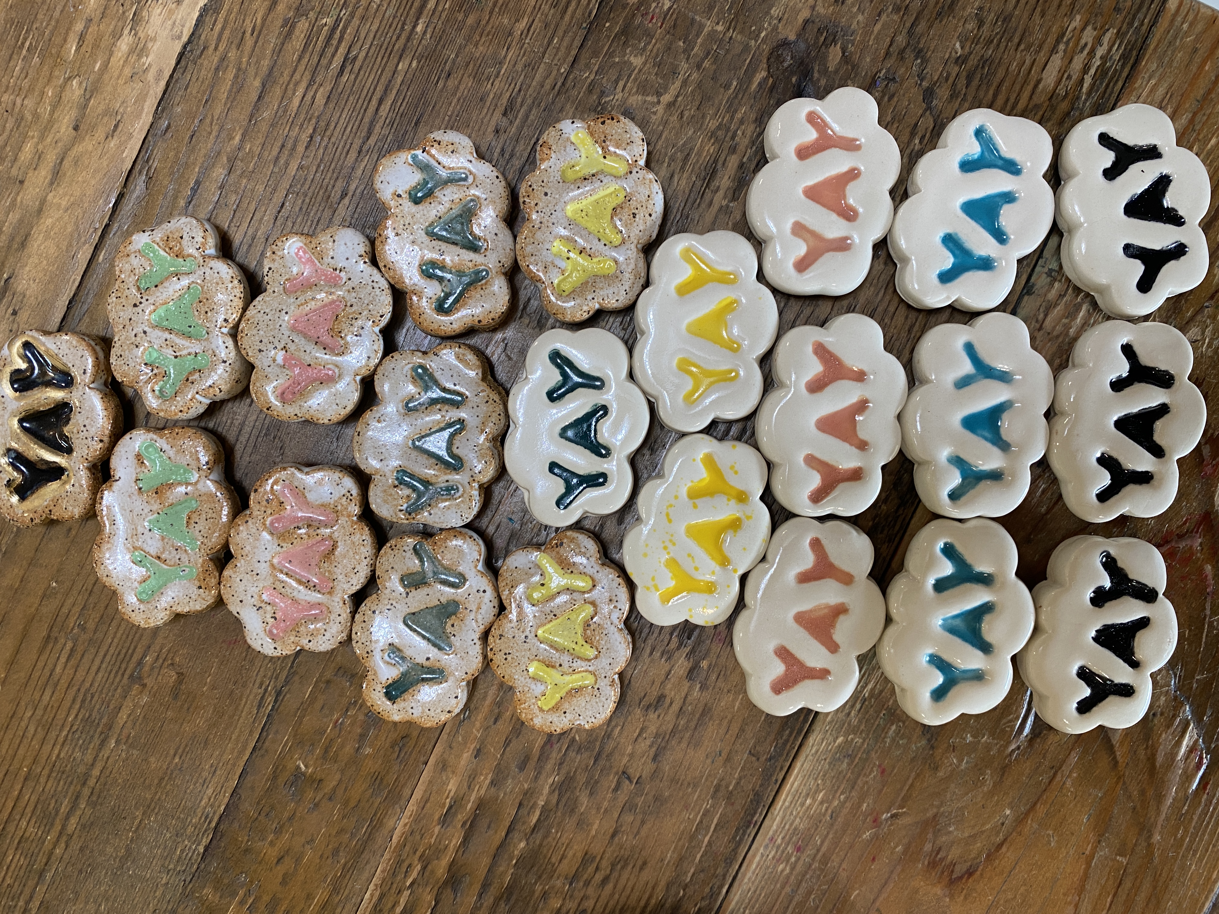 Collection of cloud-shaped ceramic coasters with YAY lettering in many colorways